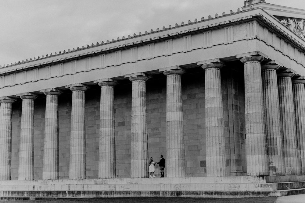 Ancient Greek-style temple with massive stone columns photographed in dramatic black and white.