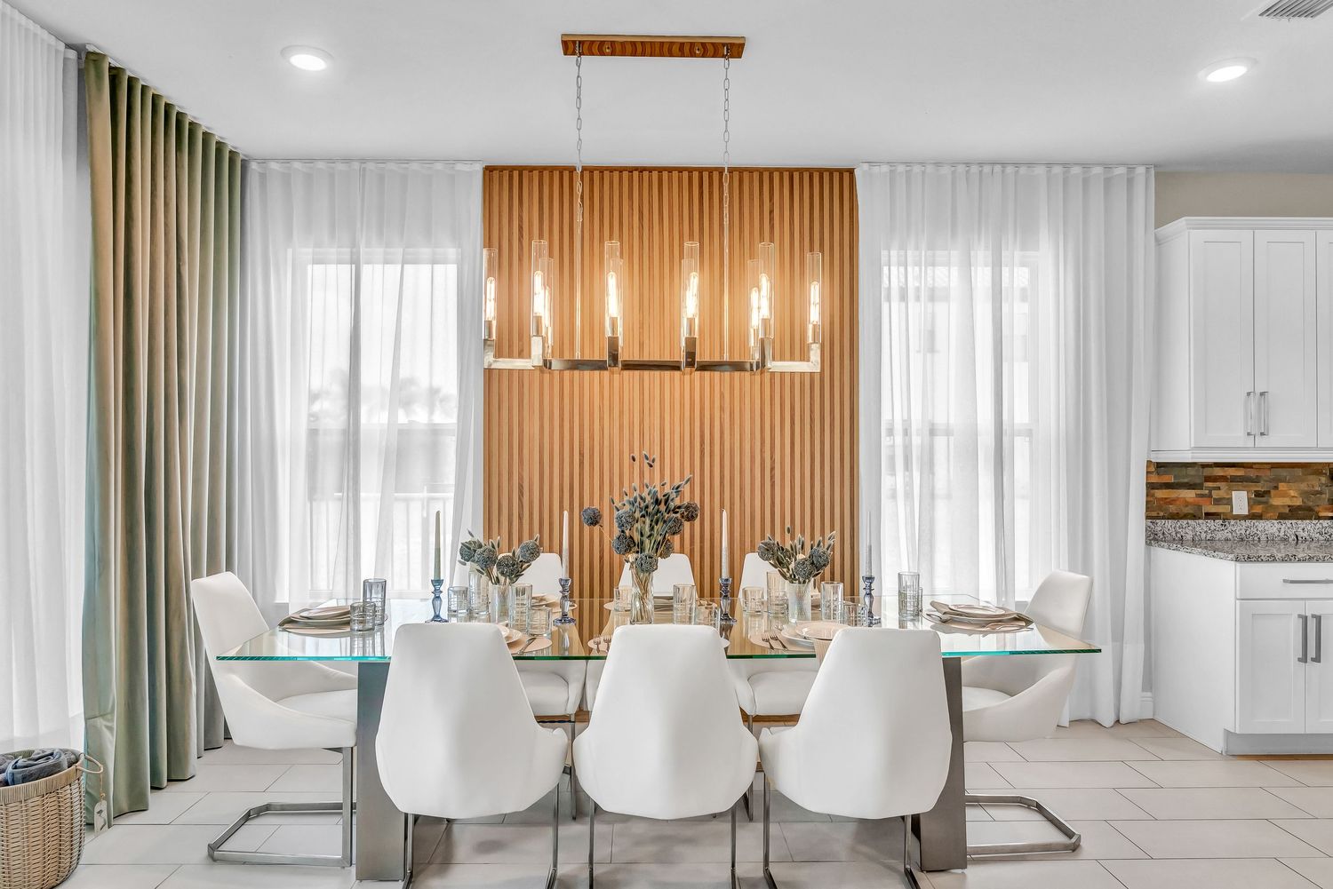 Modern white and wood open concept living room with recessed lighting  curtains features sleek contemporary design. REAL ESTATE PHOTOGRAPHY