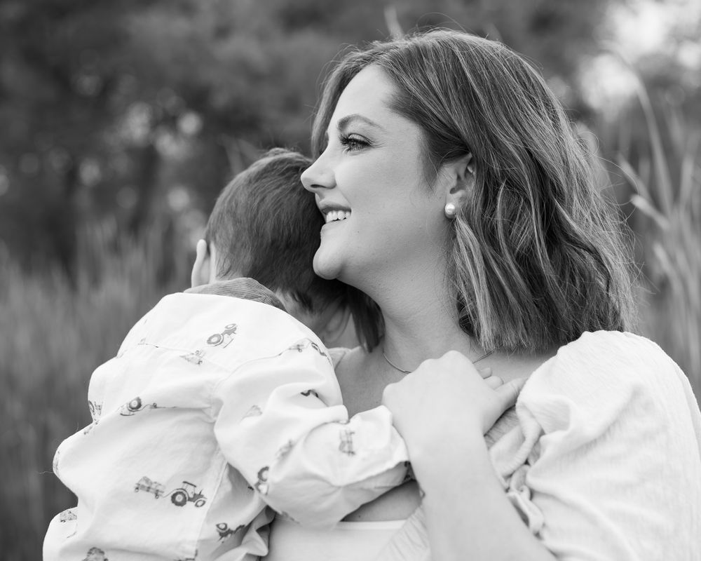 A series of black and white photos showing tender moments between parent and baby.