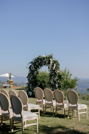 Elegant white chairs arranged outdoors for a wedding ceremony with mountain views in the background.

Auberge du Soleil Wedding
Carneros Res