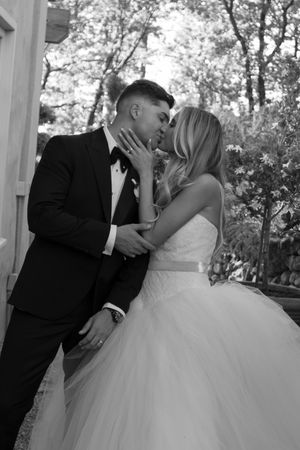 Romantic sequence of wedding couple sharing their first kiss under an outdoor gazebo.