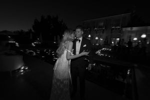 Nighttime outdoor wedding venue with lights and decorations.