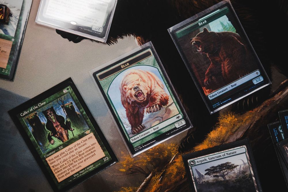 A collection of Magic: The Gathering cards laid out on a dark surface with fantasy artwork visible.