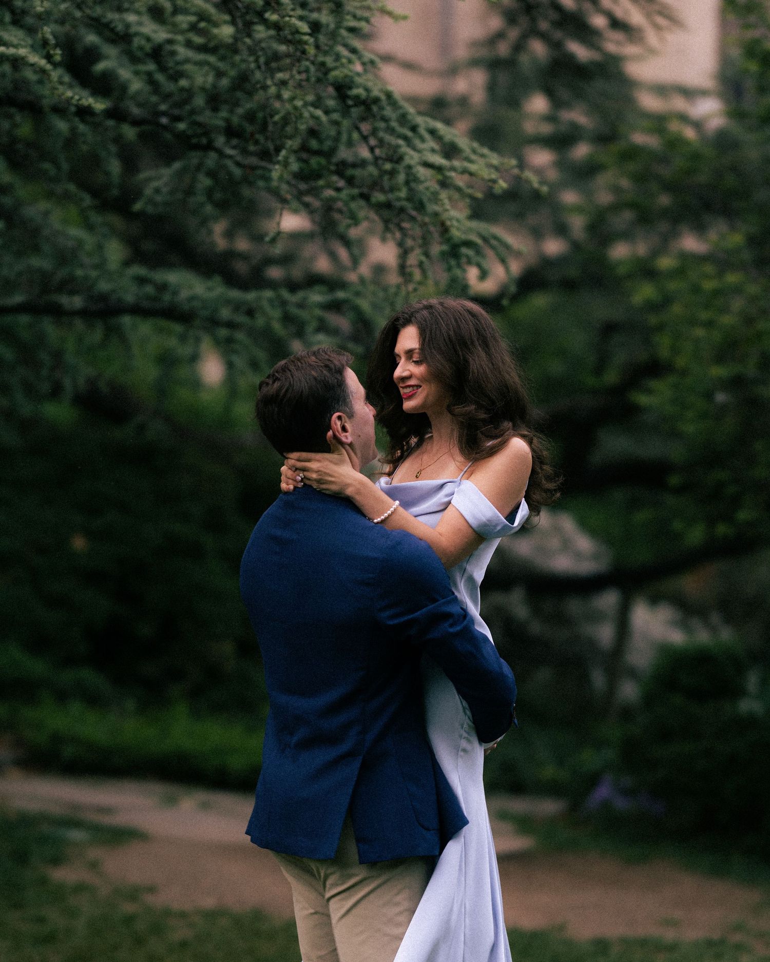 A couple during an Engagement photoshoot on bench viewing classical paintings in the National Gallery of art museum in Washington DC.