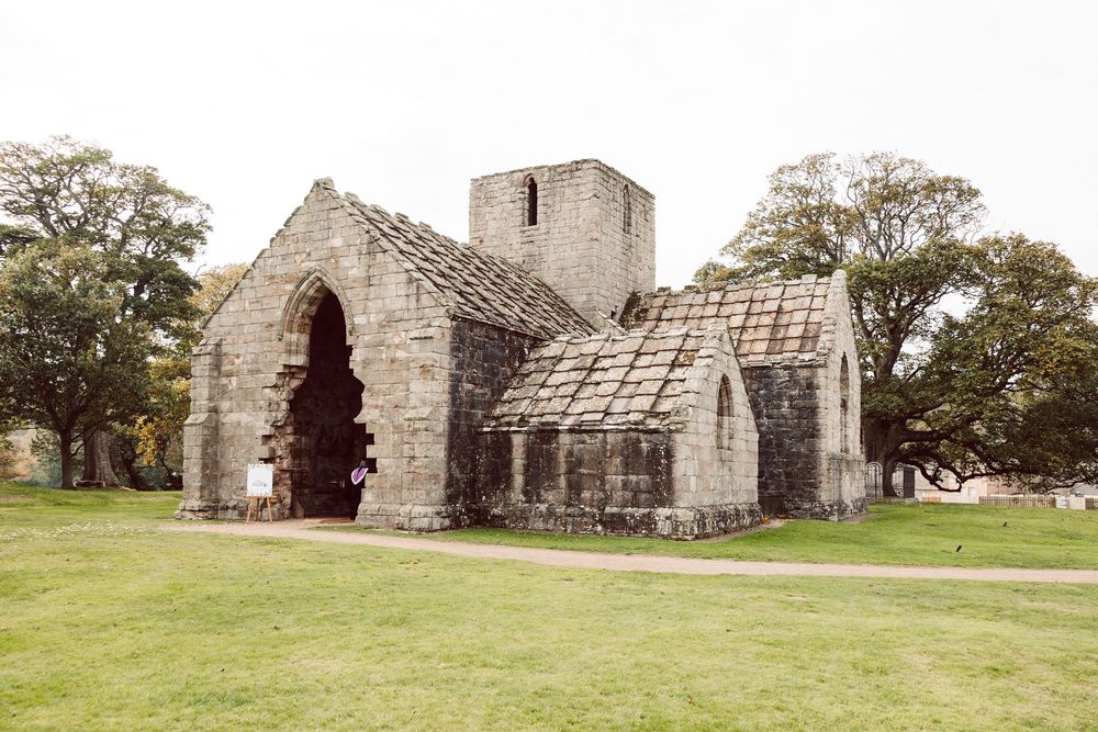 A panoramic view of a historic stone church building with multiple angles showing its architectural details and surrounding grounds.