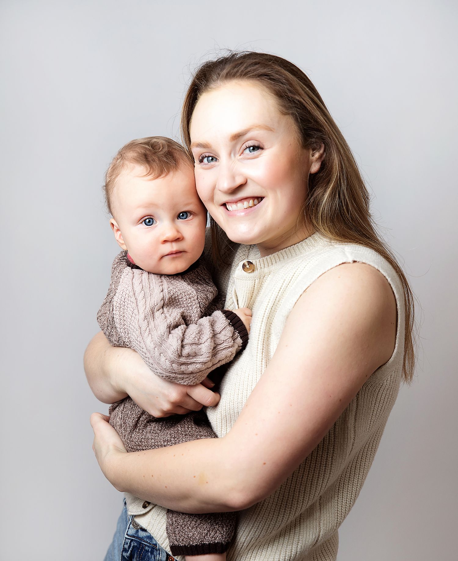 A mother and baby share tender moments in a series of intimate portraits against a light background. During a photoshoot in Bexley