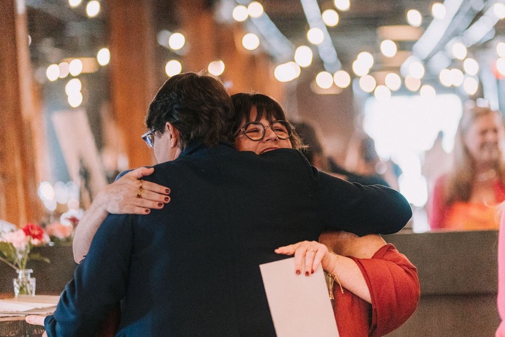 Dance floor in a rustic venue with warm lighting and couples dancing together.