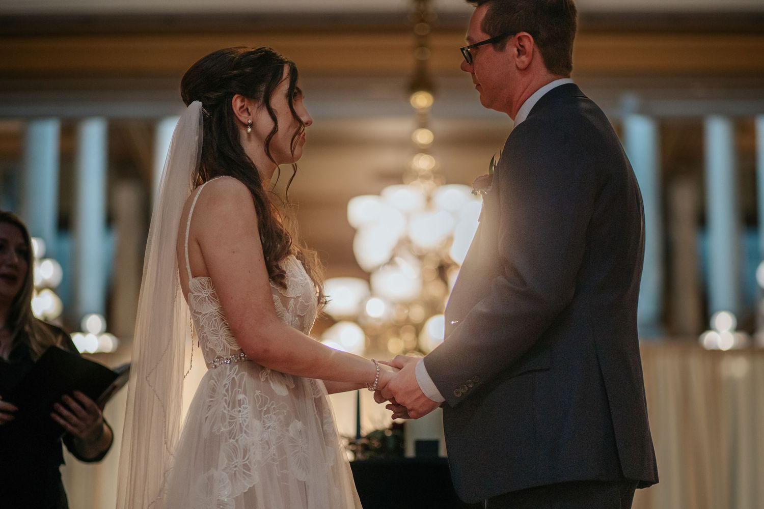 Couple sharing an intimate moment in a grand historic building with classical architecture.