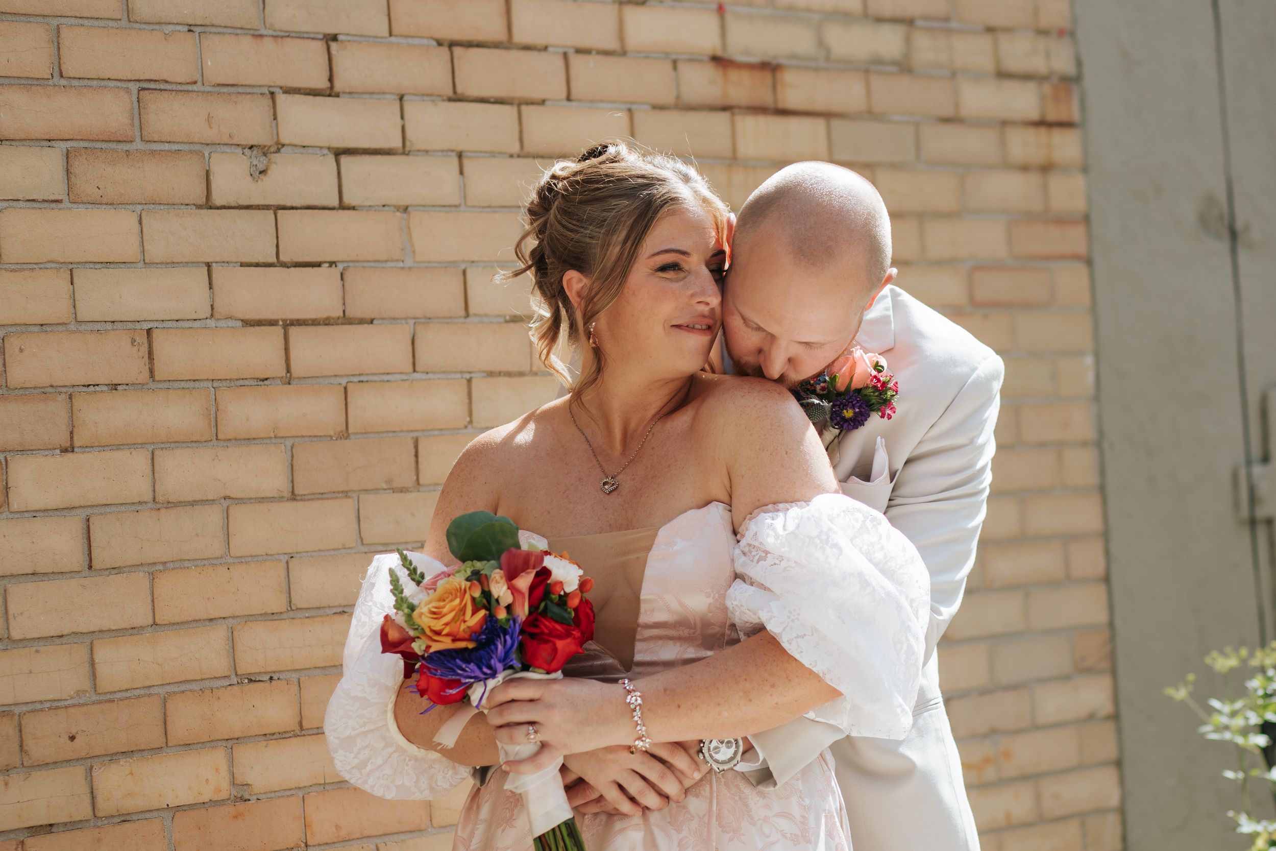 Bride and groom share tender moments in a collage of wedding photos against a brick wall backdrop.
