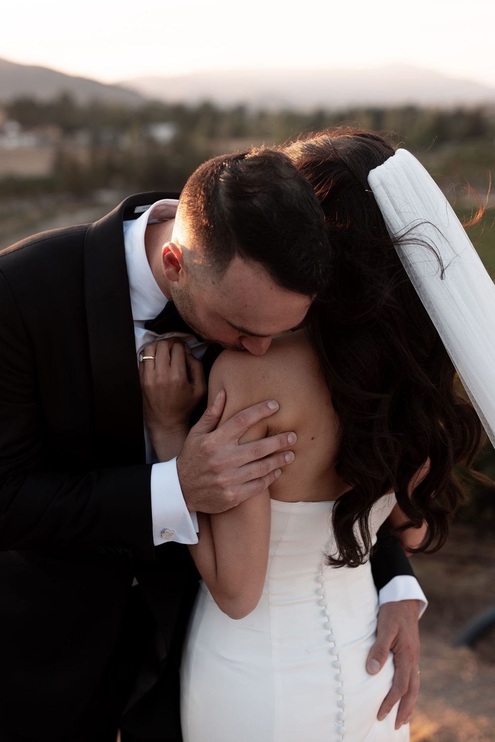 A romantic sequence of wedding photos showing a couple kissing during sunset in an outdoor setting.