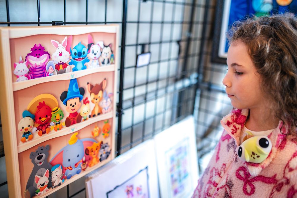Colorful plush toys and stuffed animals displayed on shelves in a retail store setting.
