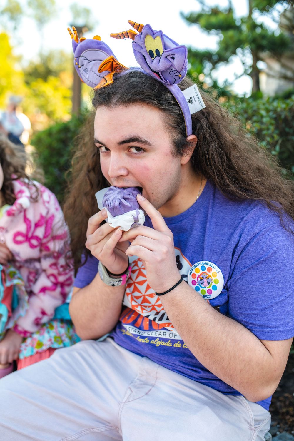 A person in a blue t-shirt takes bites of food in a sequence of four progressive photos.