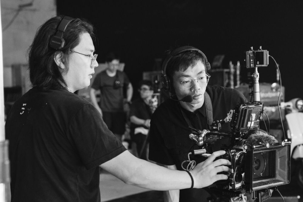 A black and white photo sequence shows a person operating a film camera from different angles during a production shoot.