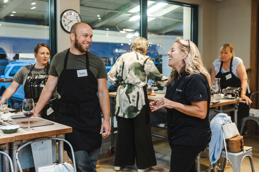 Attendees mingle and network during a professional business event in a modern office space.