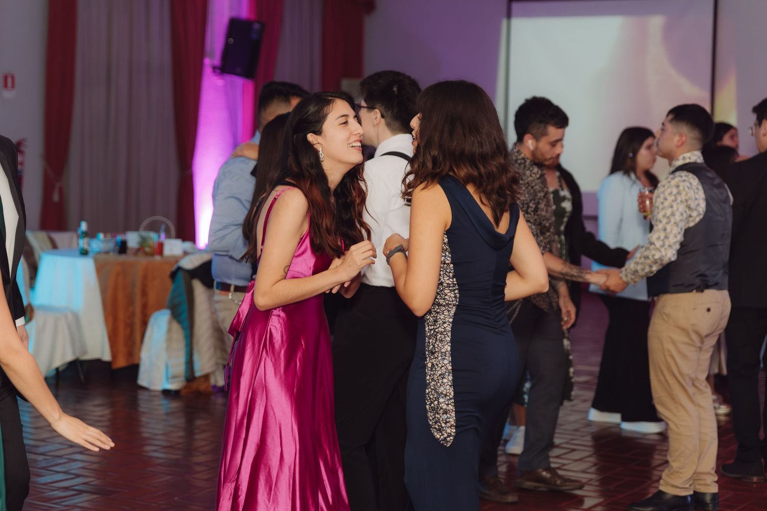 Couple sharing a kiss while dancing at an elegant wedding reception celebration.
