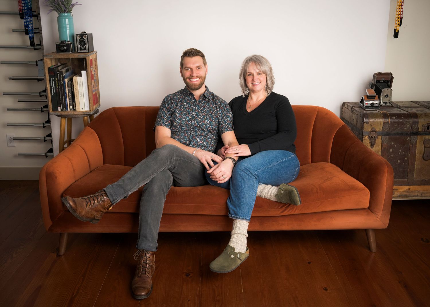 A sequence of six similar photos showing two people sitting together on wooden chairs against a neutral background.