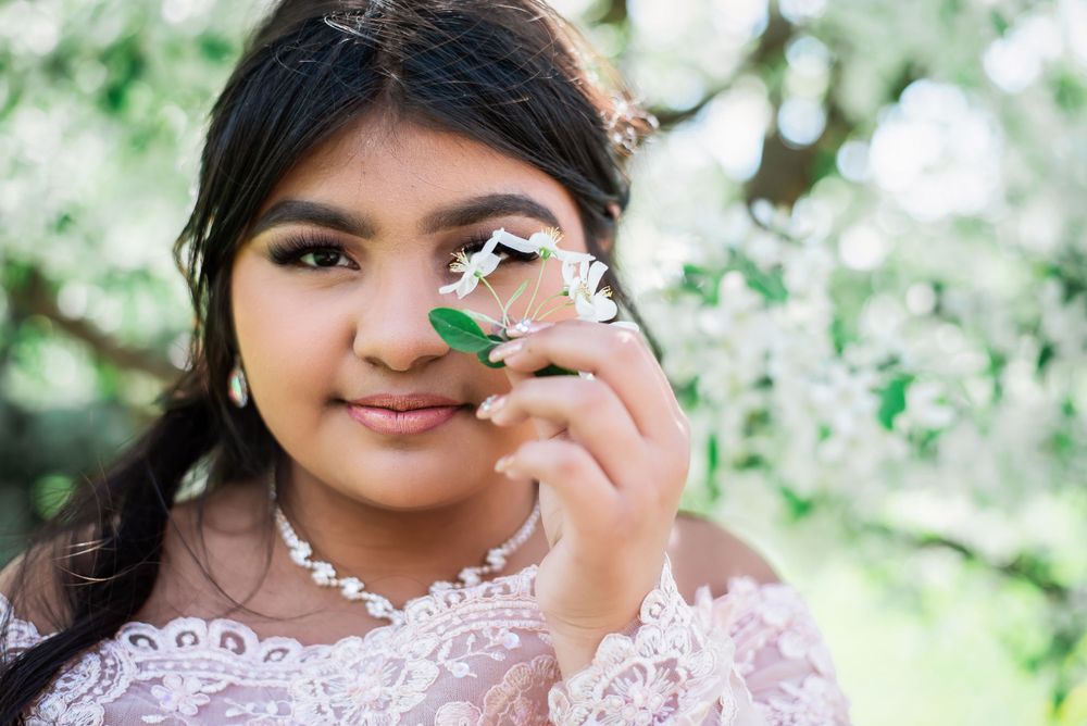 Delicate portrait session featuring soft lighting and floral elements.