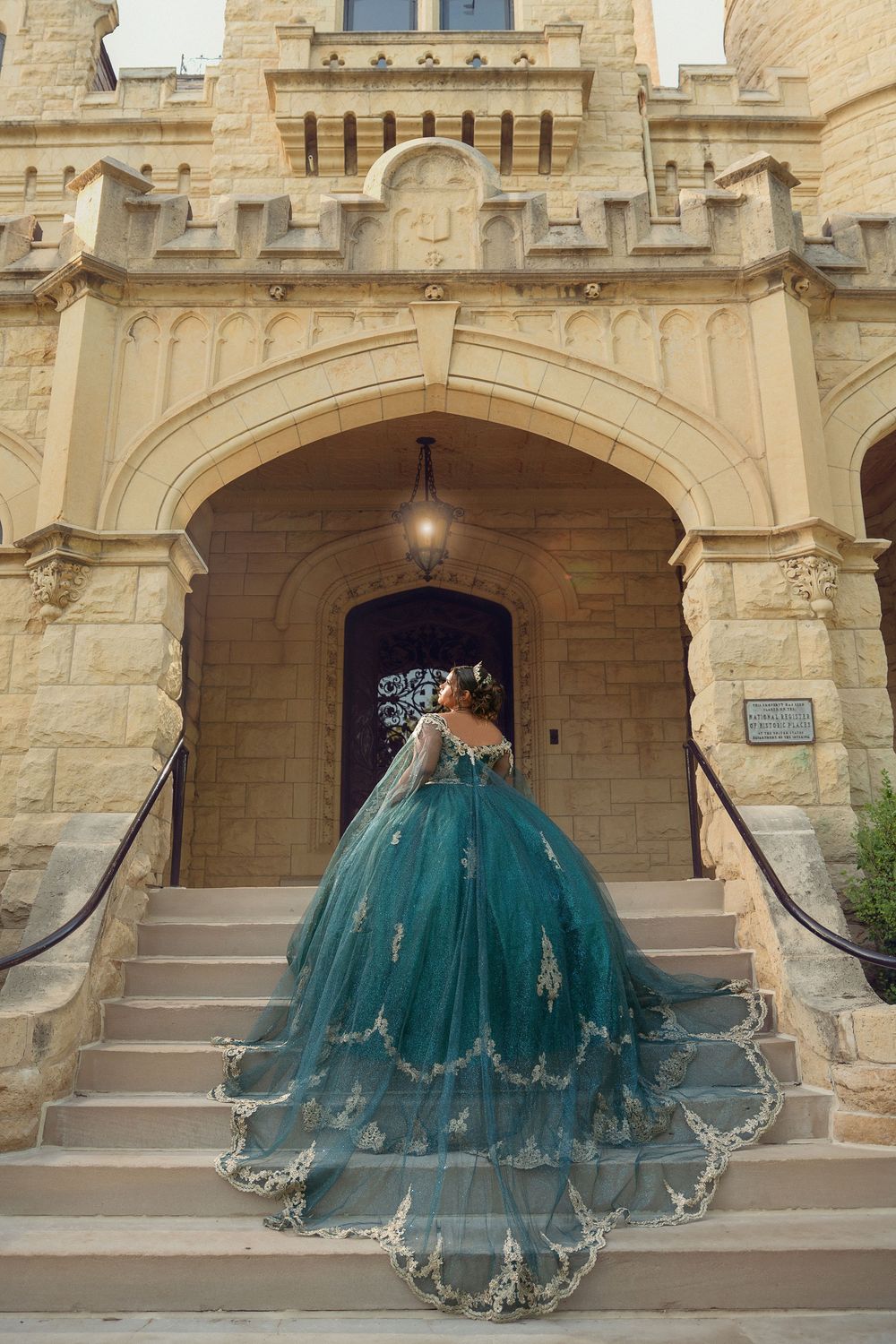 Teal ball gown photographed in sequence against stone archways of a historic building.