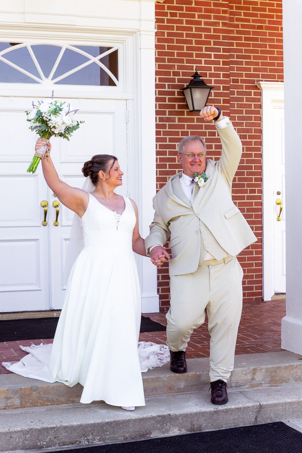 A couple in white wedding attire dance playfully on a brick porch in a series of candid shots.
