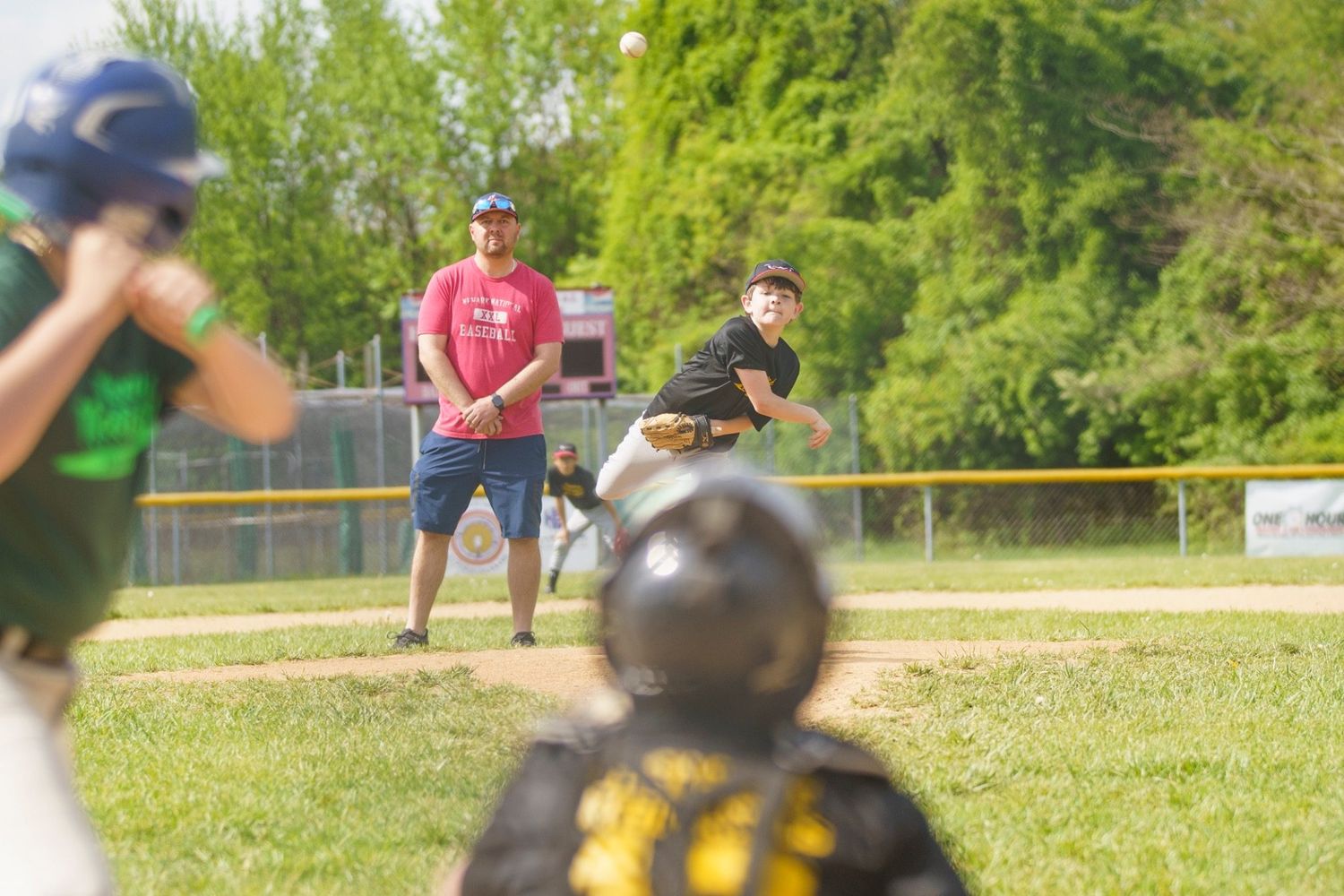 Youth baseball action photo captured with the Sony A7iii freezing motion outdoors