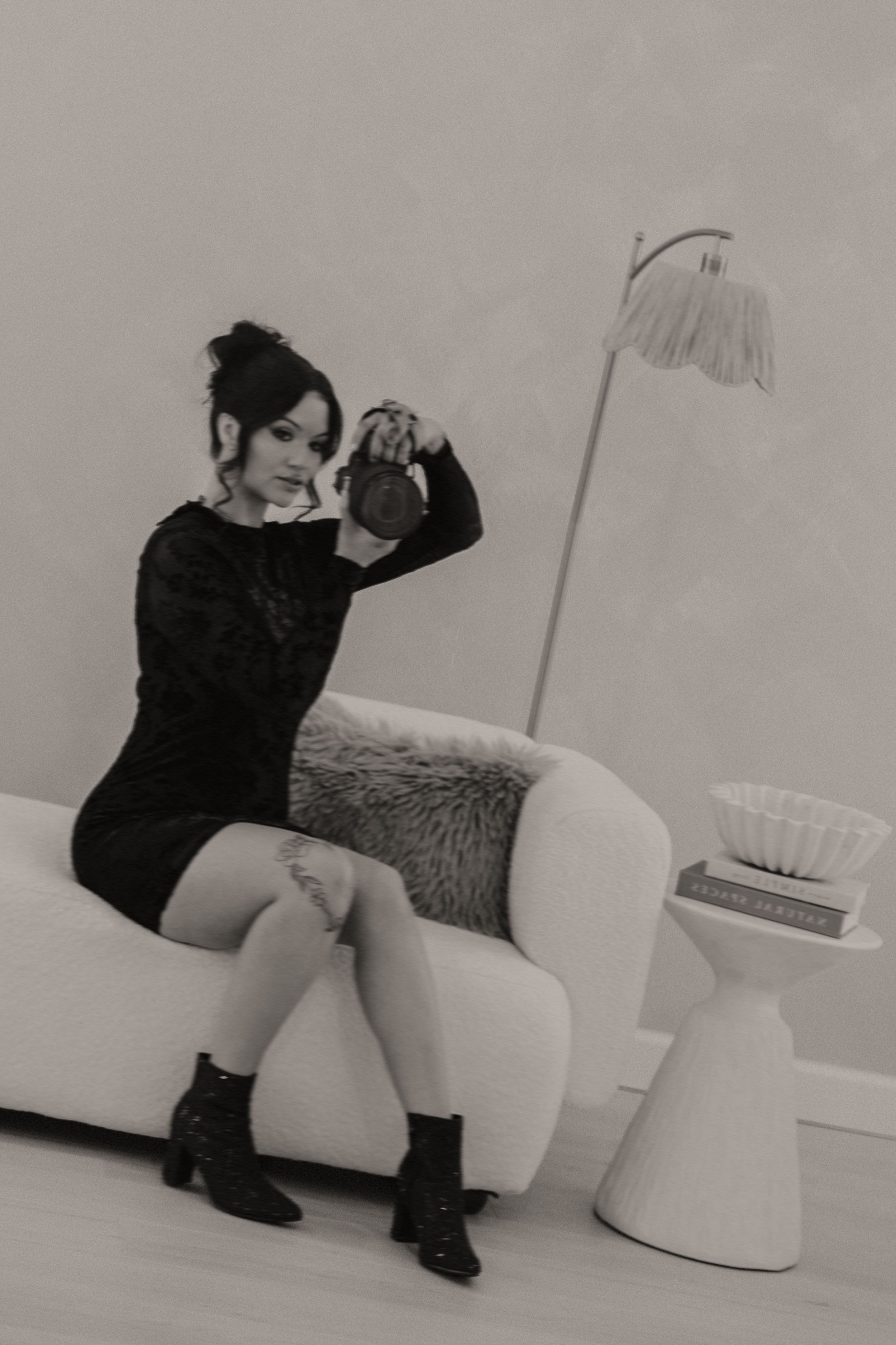 A sequence of black and white photos showing someone sitting and interacting with a modern white chair.