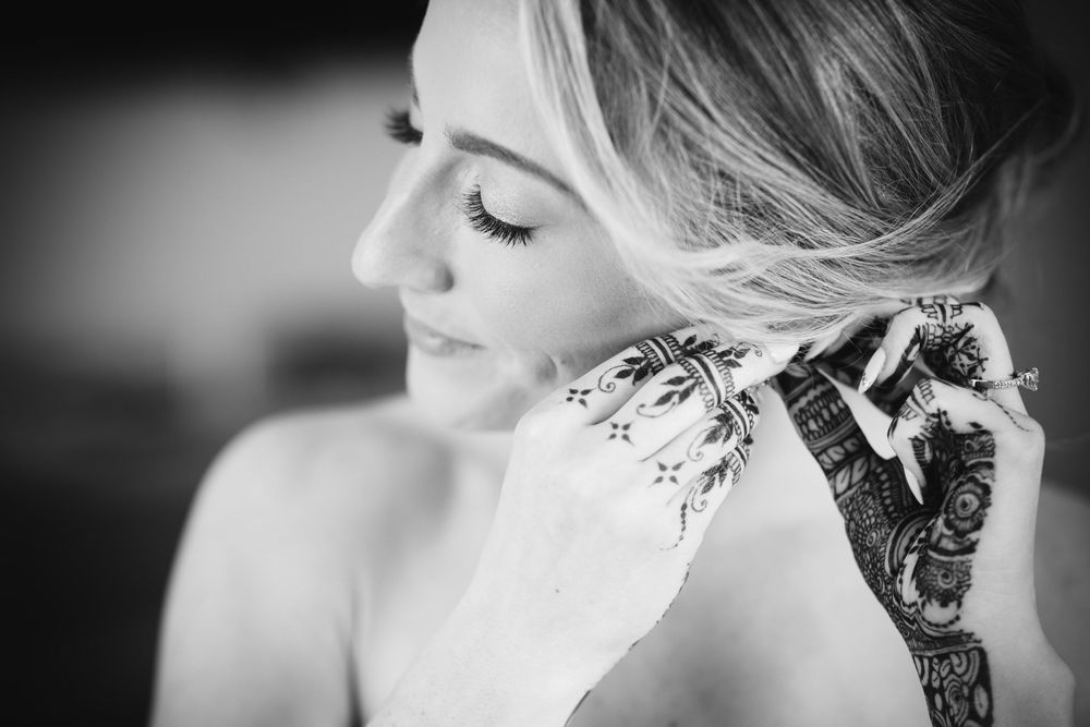 A series of monochrome close-up shots showing bridal preparation details with elegant styling.