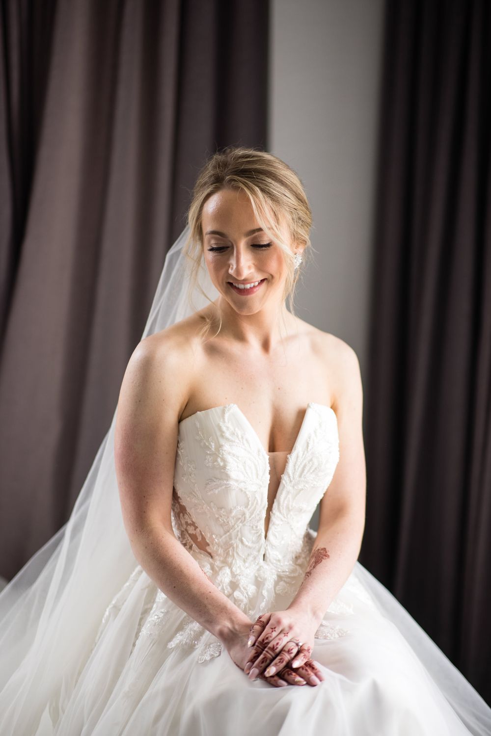 Close-up details of a white lace wedding dress with delicate beading and embroidery.