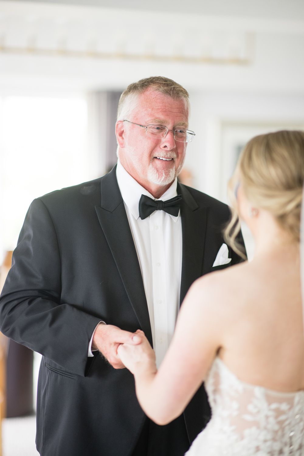 A series of emotional first look moments between a bride and someone in formal attire during a wedding day.