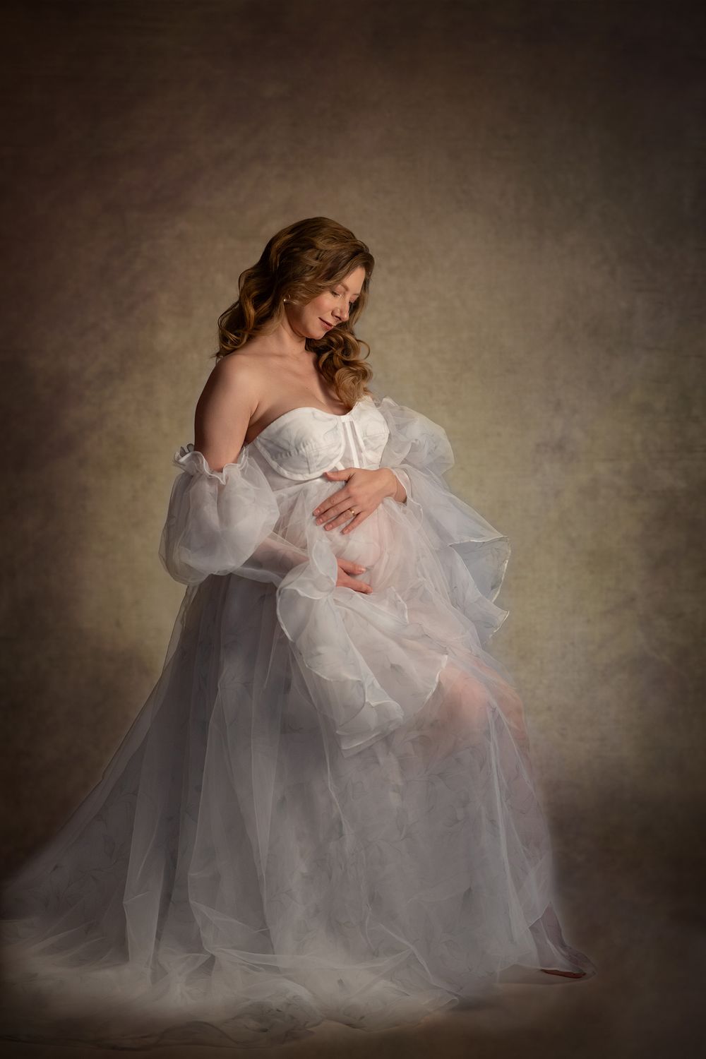 Dreamy artistic portrait showcasing billowing white gown with dramatic shadows and textural elements.