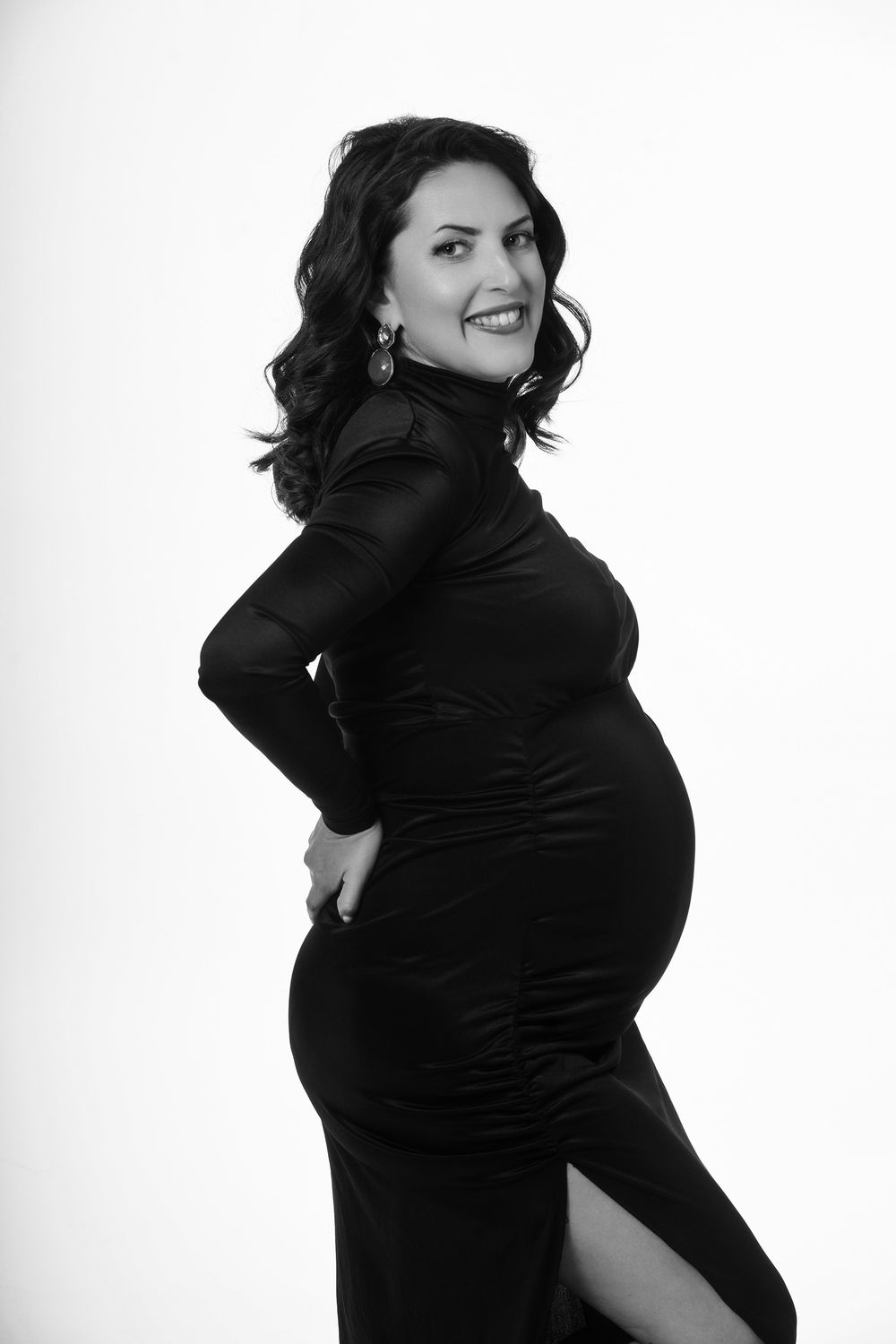 Black and white portrait series showing a woman in black clothing posing against a white background.