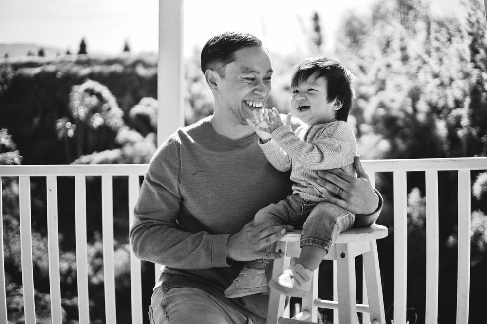 A heartwarming black and white moment captured on an outdoor deck.