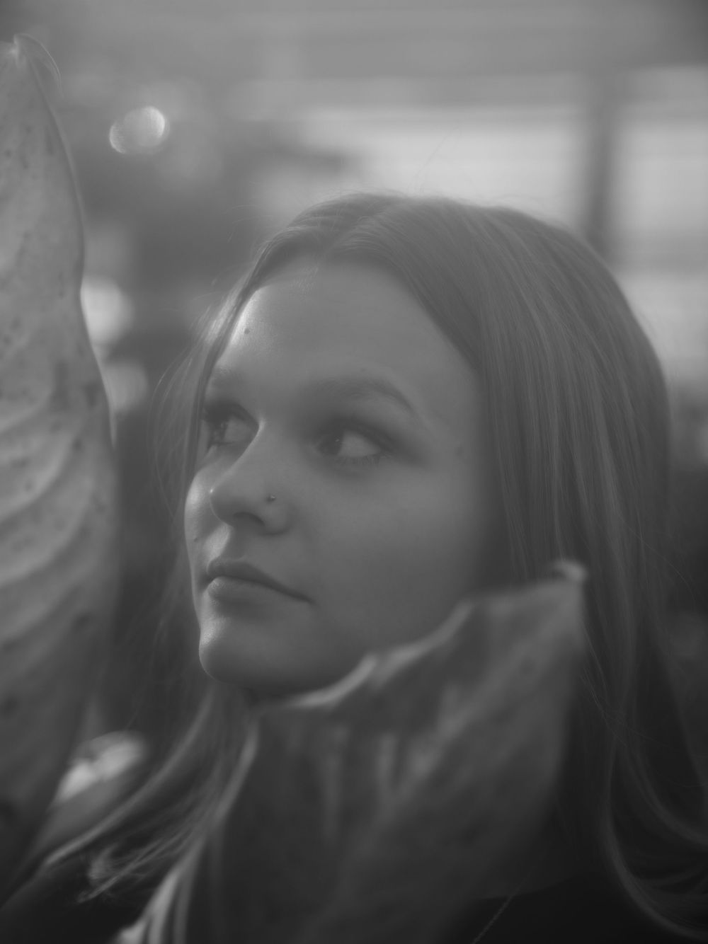 Dreamy black and white portrait with soft bokeh lighting effects.