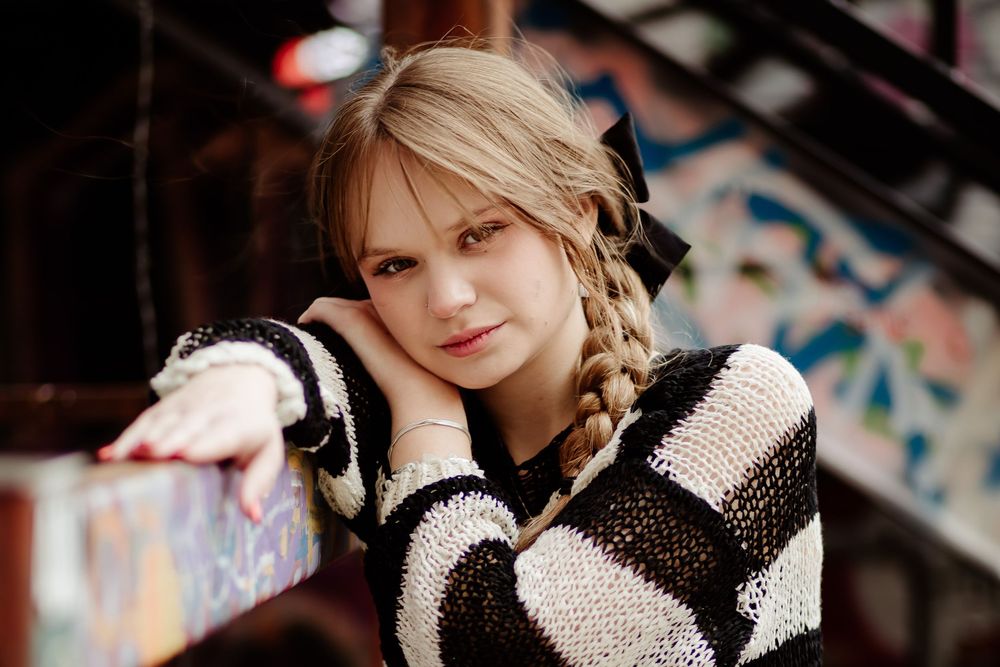 Artistic close-up portraits with dramatic lighting and textured black clothing.