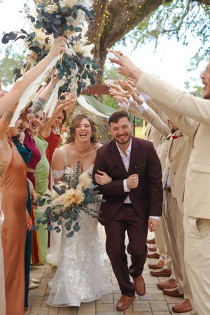 Wedding guests toss confetti over the newlyweds during their celebratory exit.