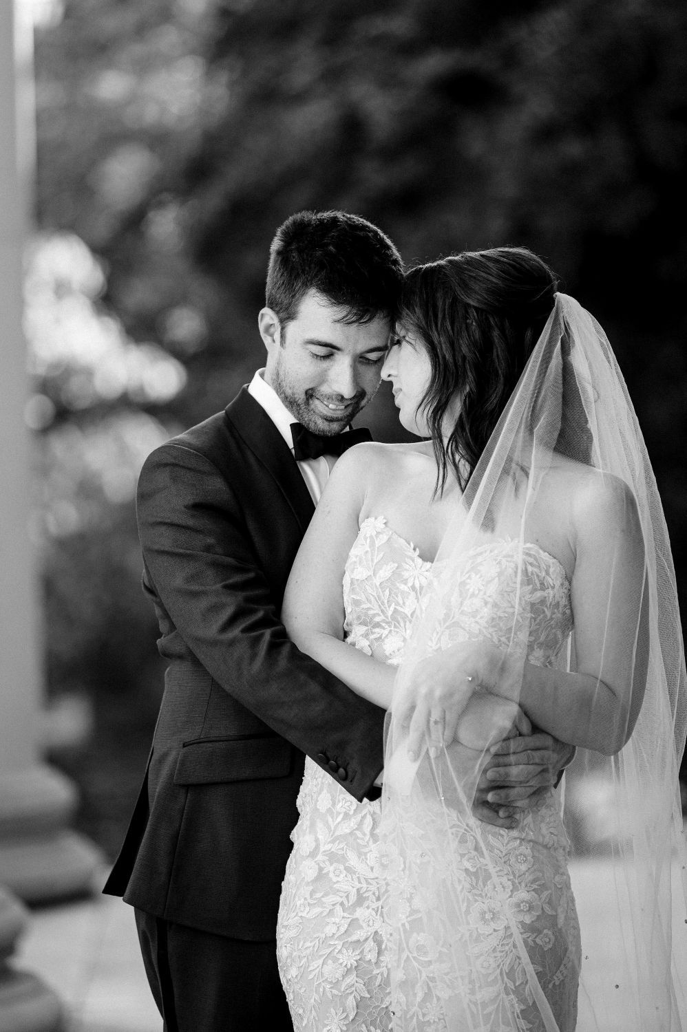 A romantic black and white series of wedding photos showing tender moments between newlyweds.