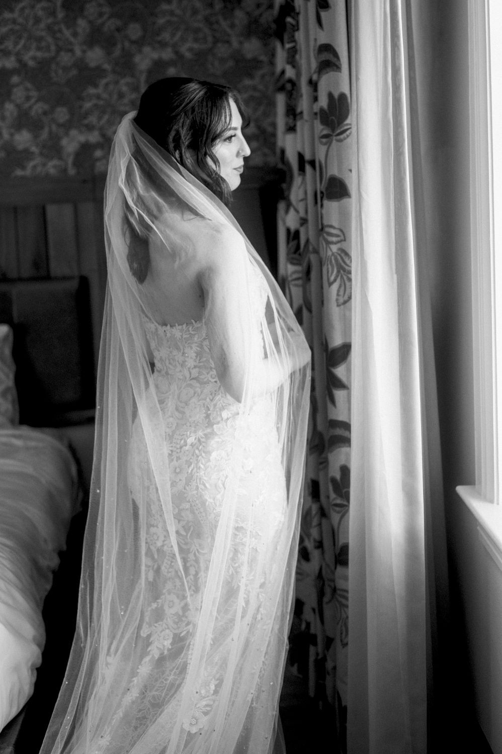 A series of artistic silhouettes showing a bride in a flowing white dress and veil against window light.