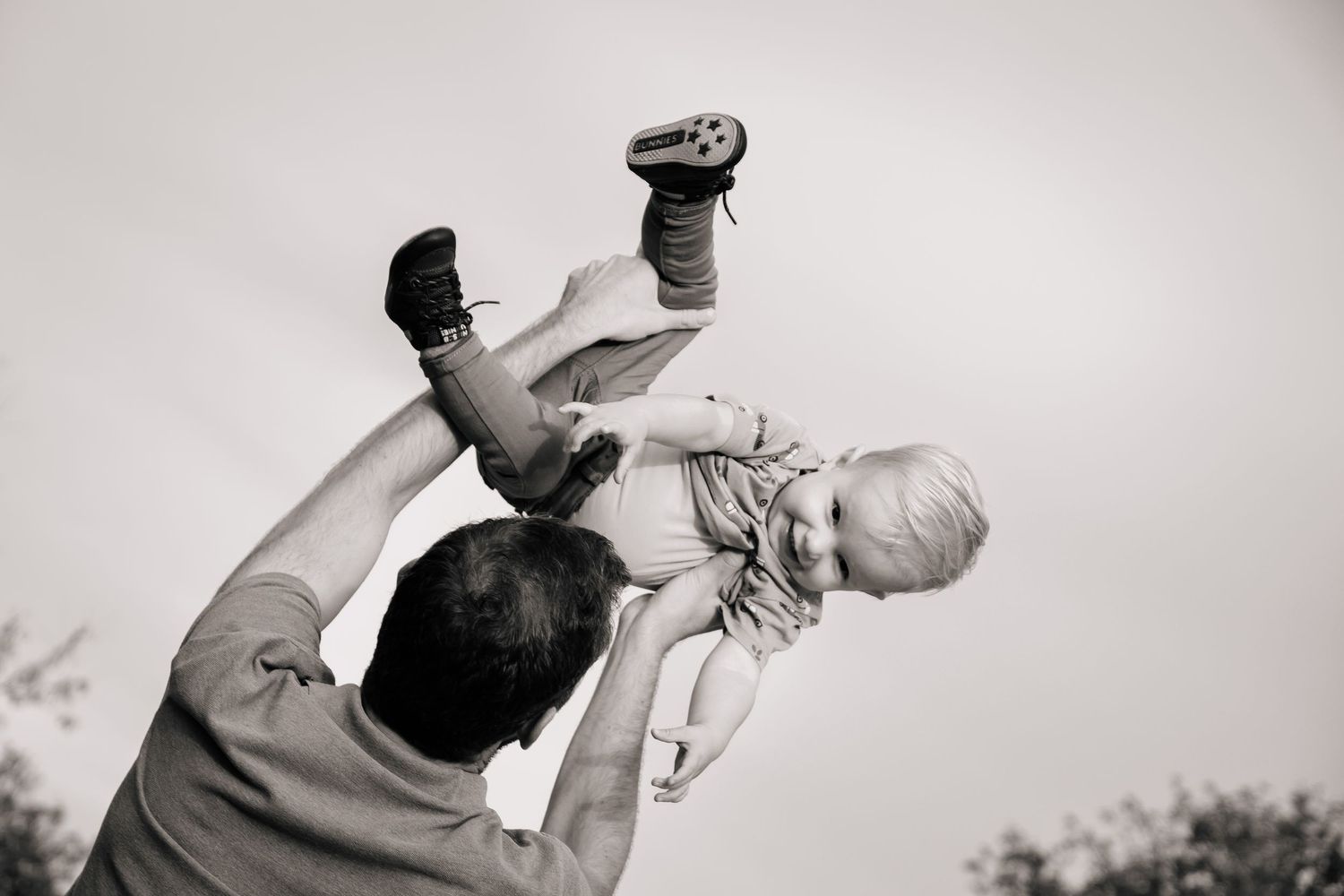 Black and white photo series showing dance movements with graceful lifts and poses against a light background.