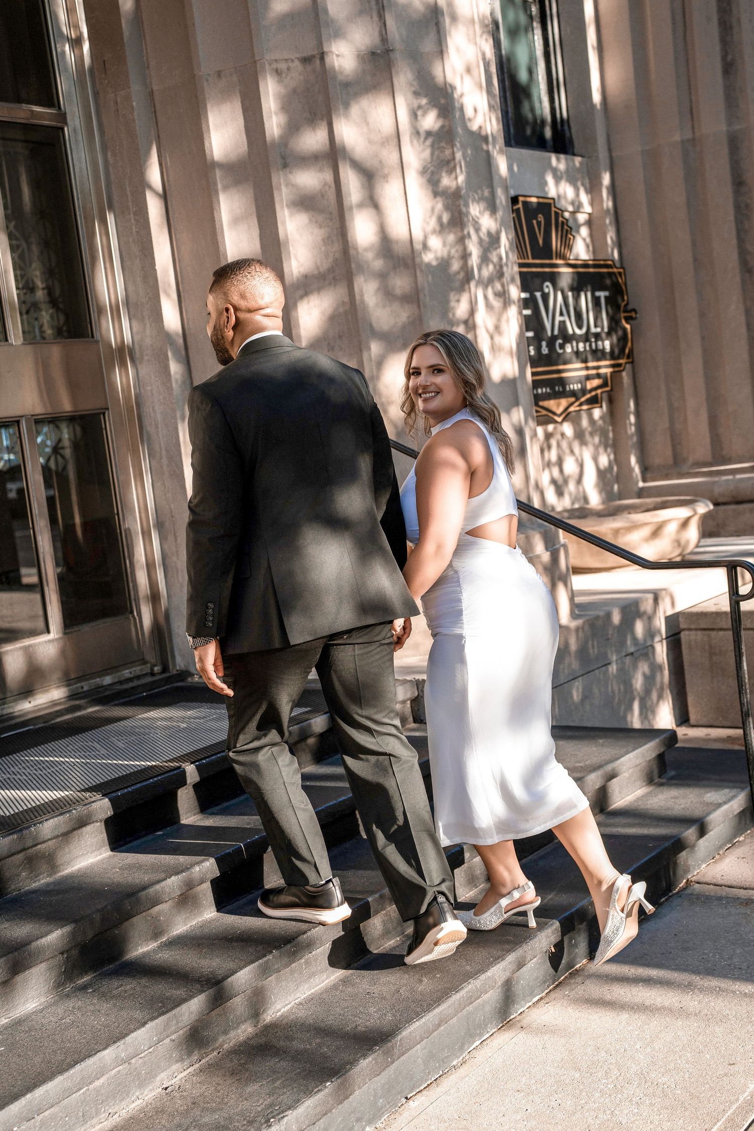 A sequence of photos showing two people walking together along a sunlit urban sidewalk in summer in Downtown Tampa
