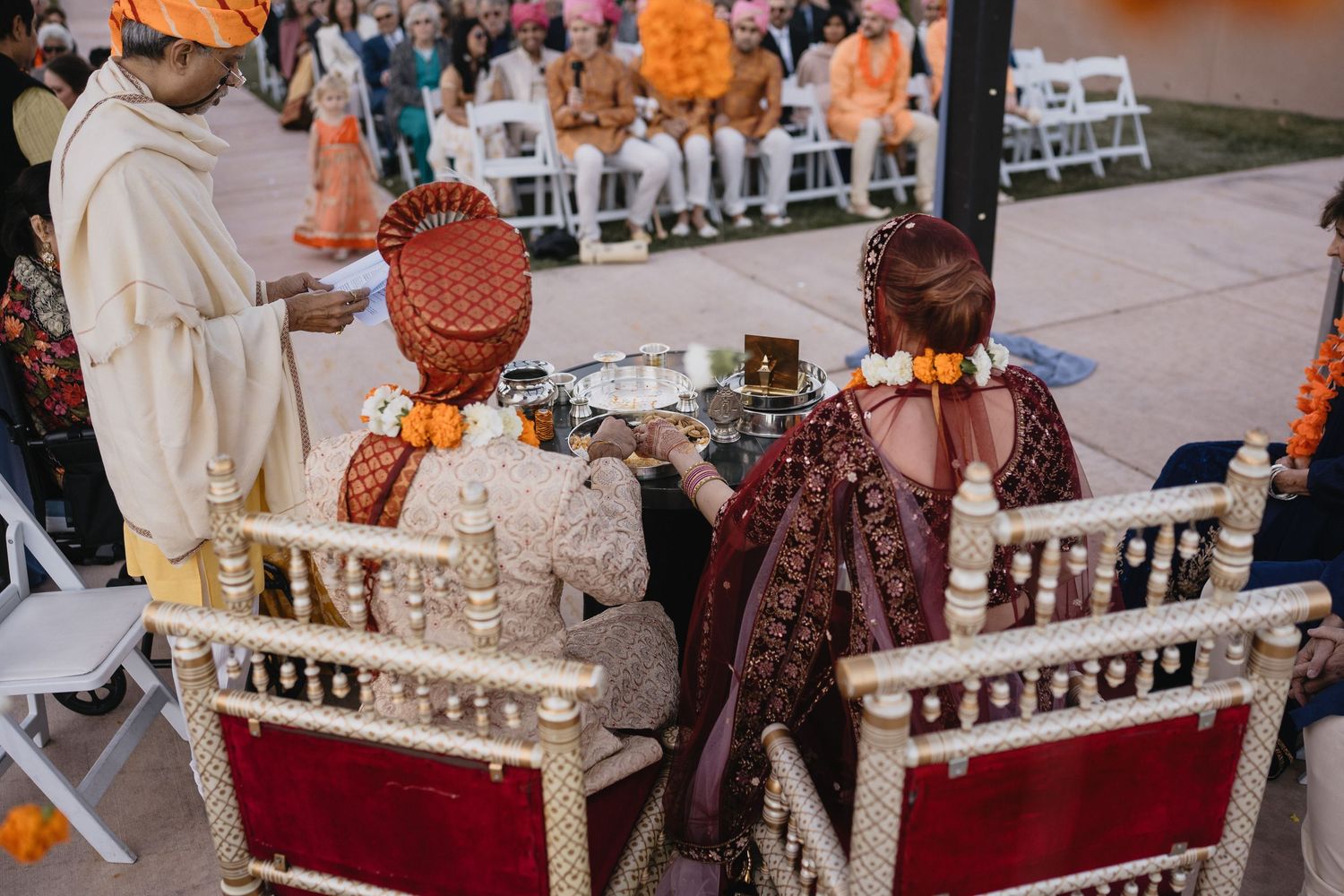 Indian bride and groom seated at ornate chairs during traditional Hindu wedding ceremony.at Sandia Resort and Casino