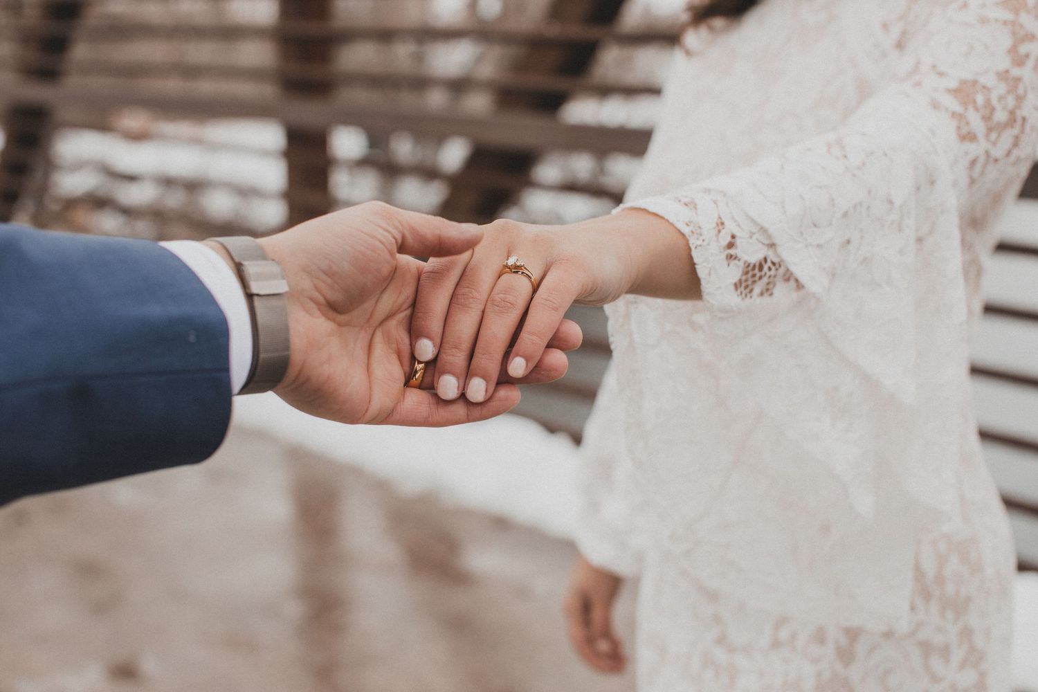 A series of wedding photos showing close-up shots of hands holding each other during a romantic ceremony.