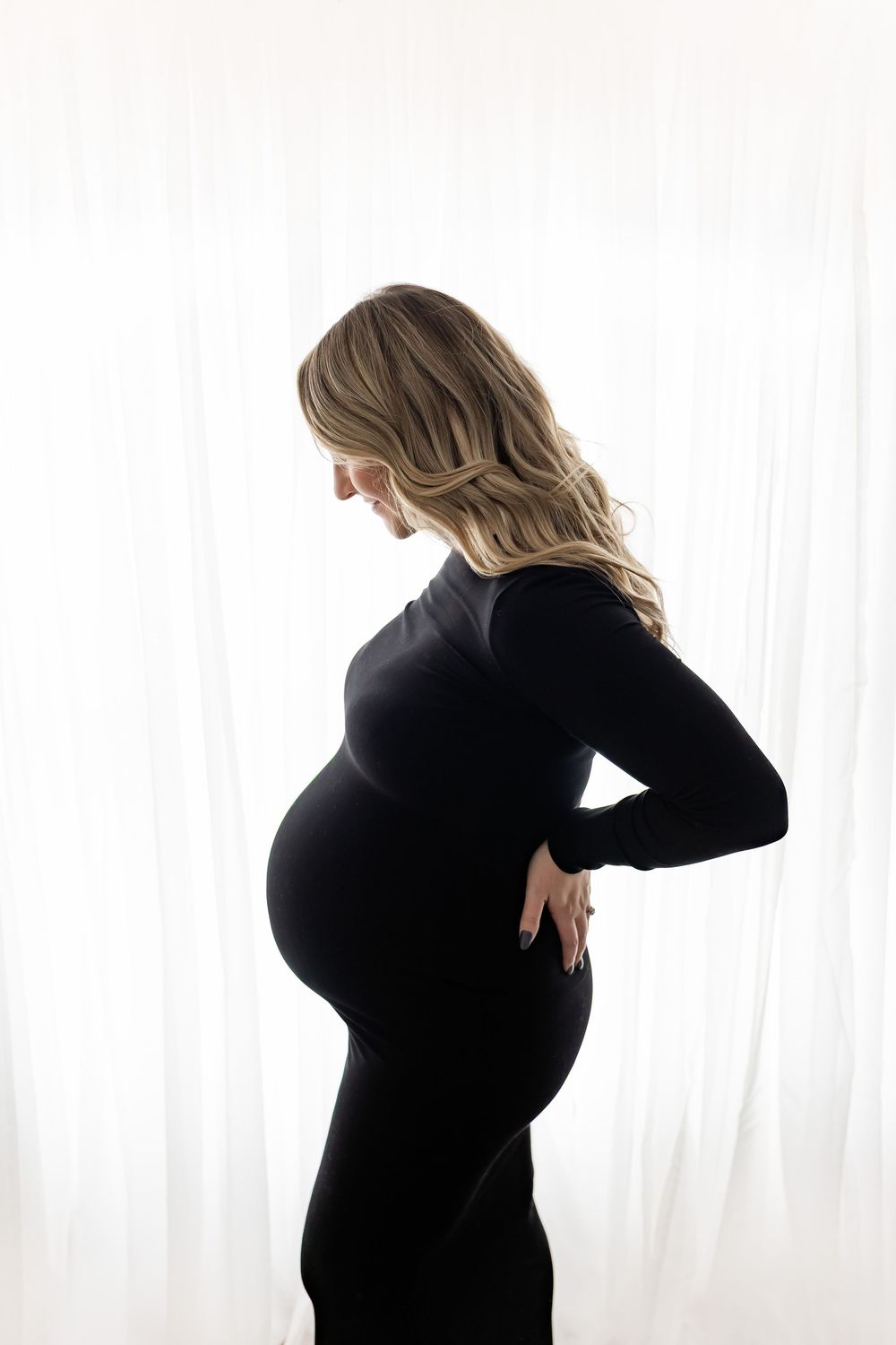 A silhouetted figure in black clothing stands against a white background in three different poses.