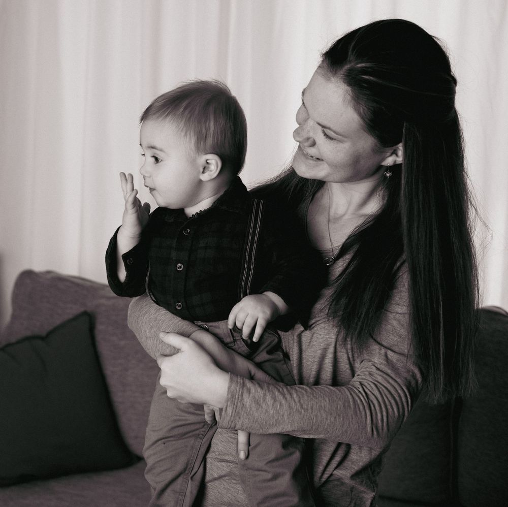 A series of black and white photos showing tender moments between parent and child in intimate poses.