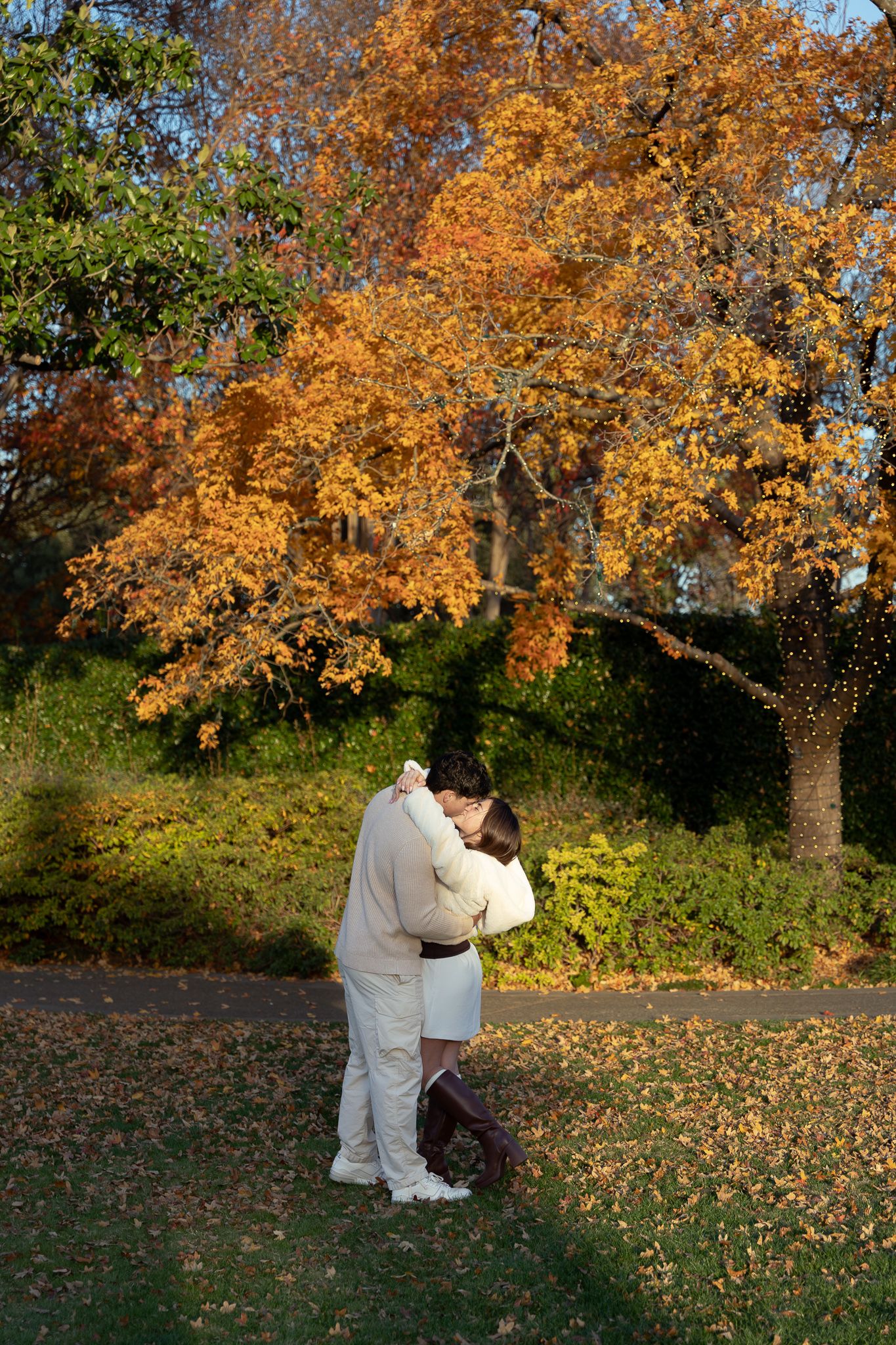 Luxury engagement proposal at Dallas Arboretum with couple smiling and hugging