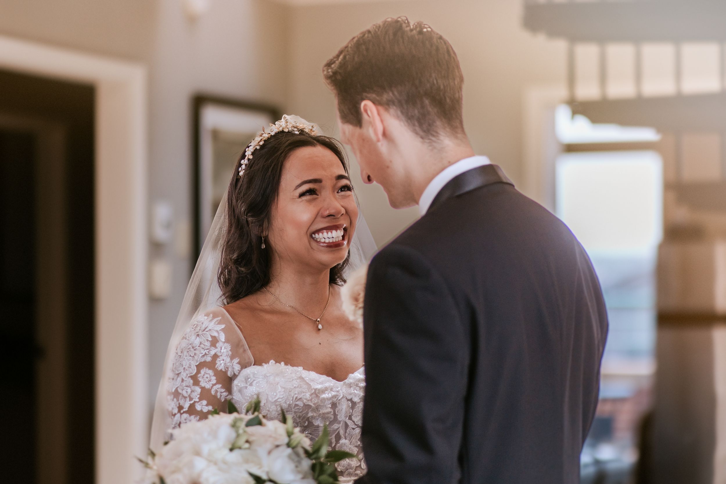 Newlywed couple sharing intimate moments and laughter during their wedding photo session.