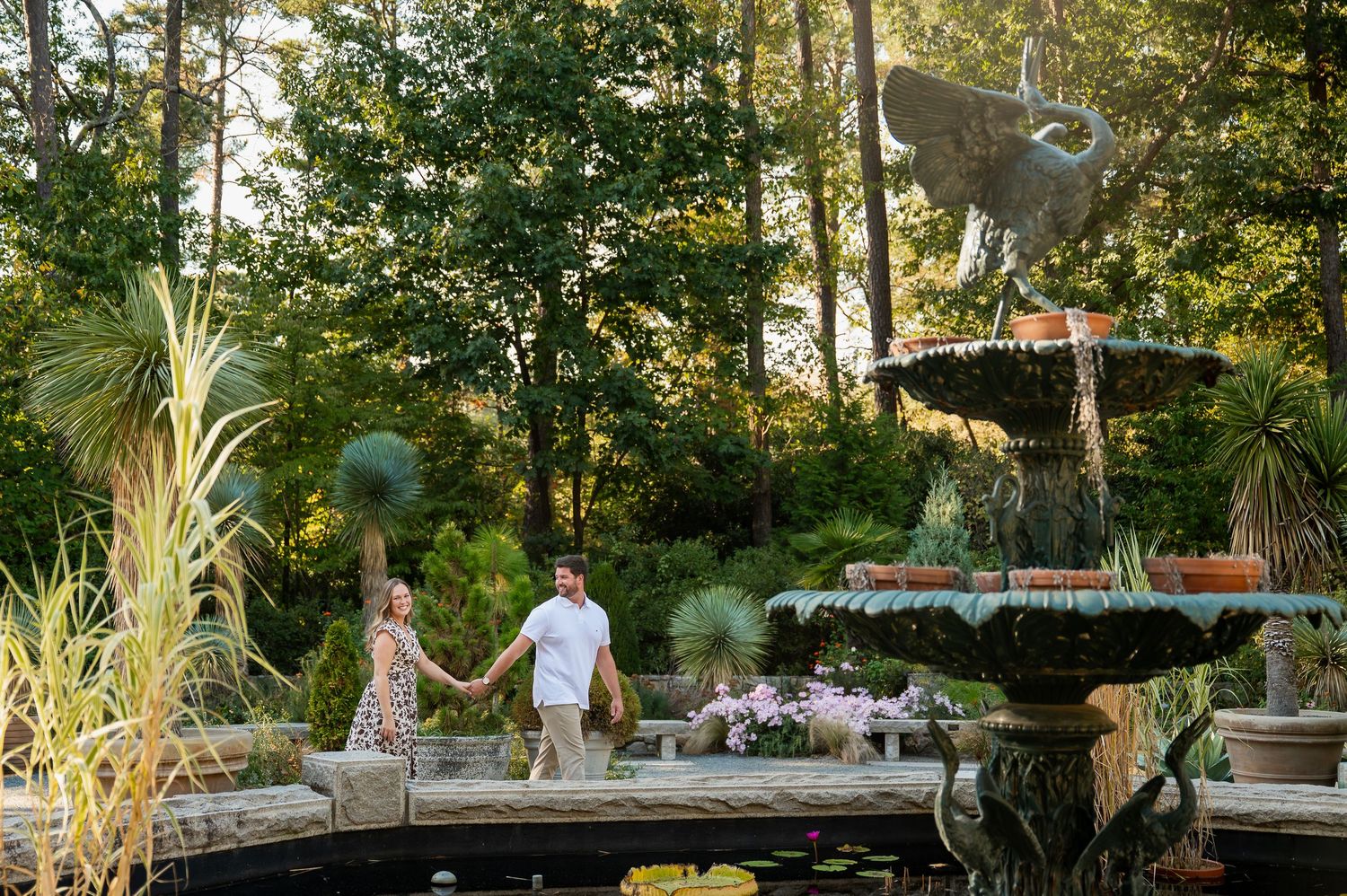 Romantic couple's portrait session on a rustic garden bench at sunset.