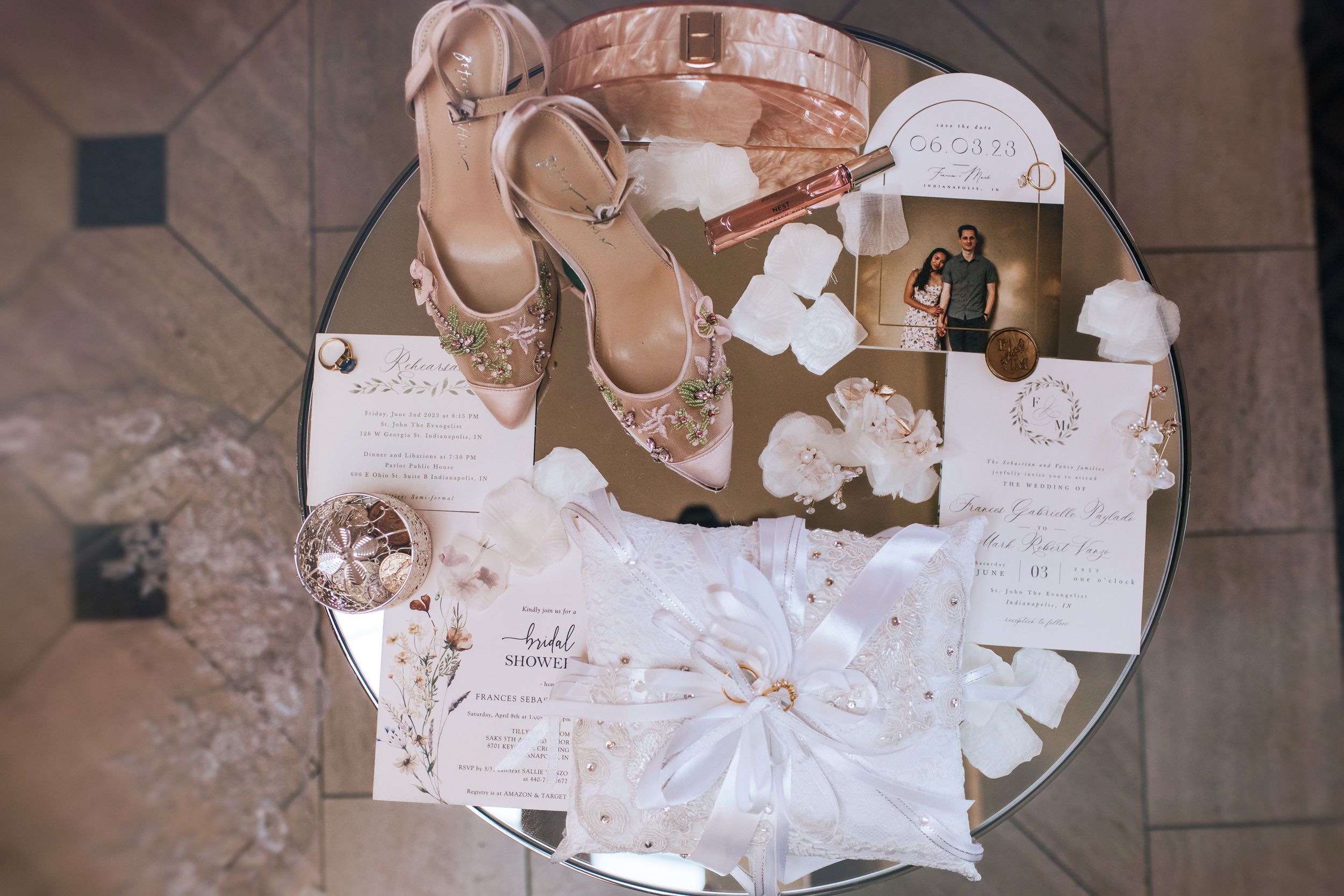 Torn paper scraps and fragments scattered on a beige tile floor showing bits of handwritten text and designs.