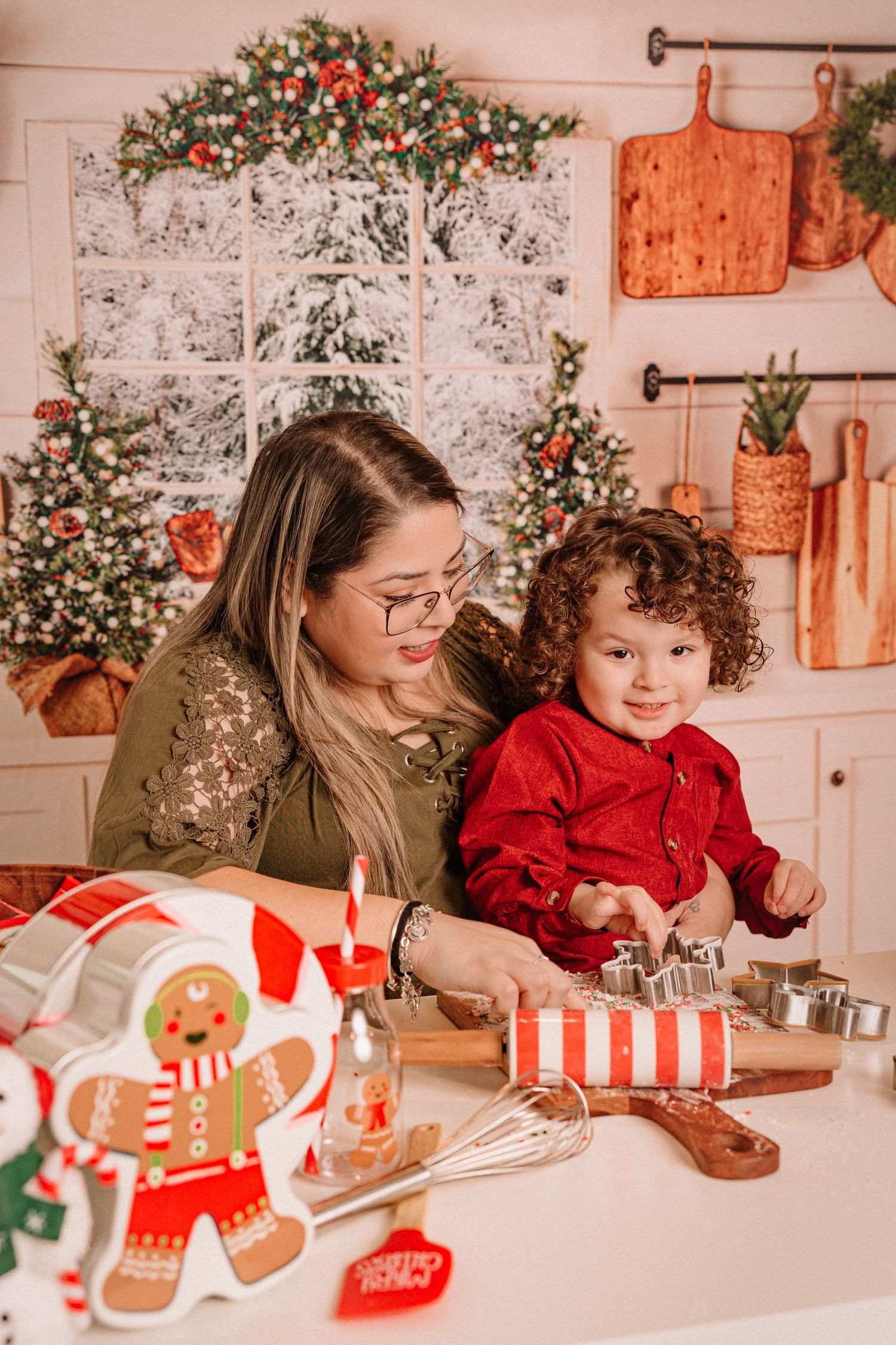 A cozy kitchen scene shows holiday baking with cookie cutters and festive decorations.