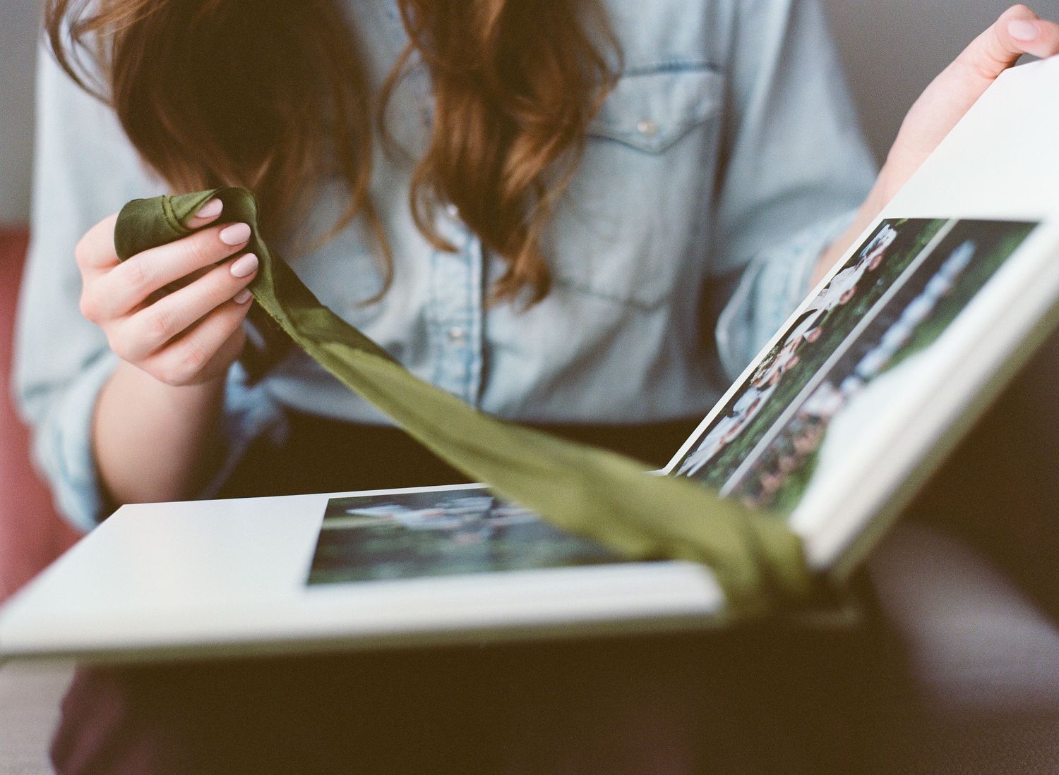 Person reading a book or document in a dimly lit environment.