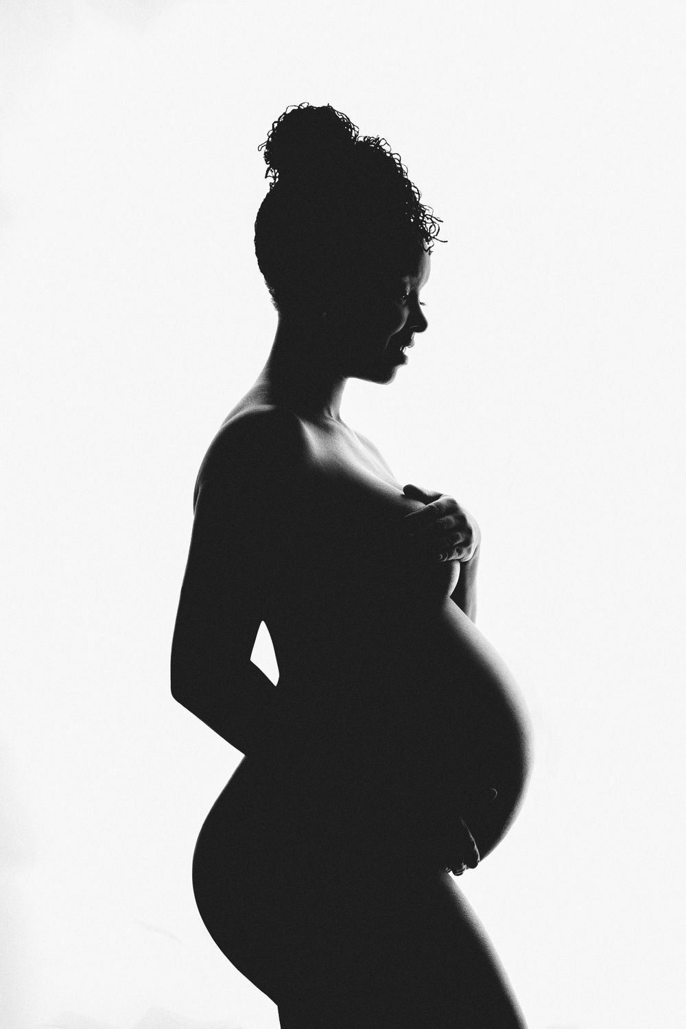 High contrast black and white silhouette of an expectant figure.