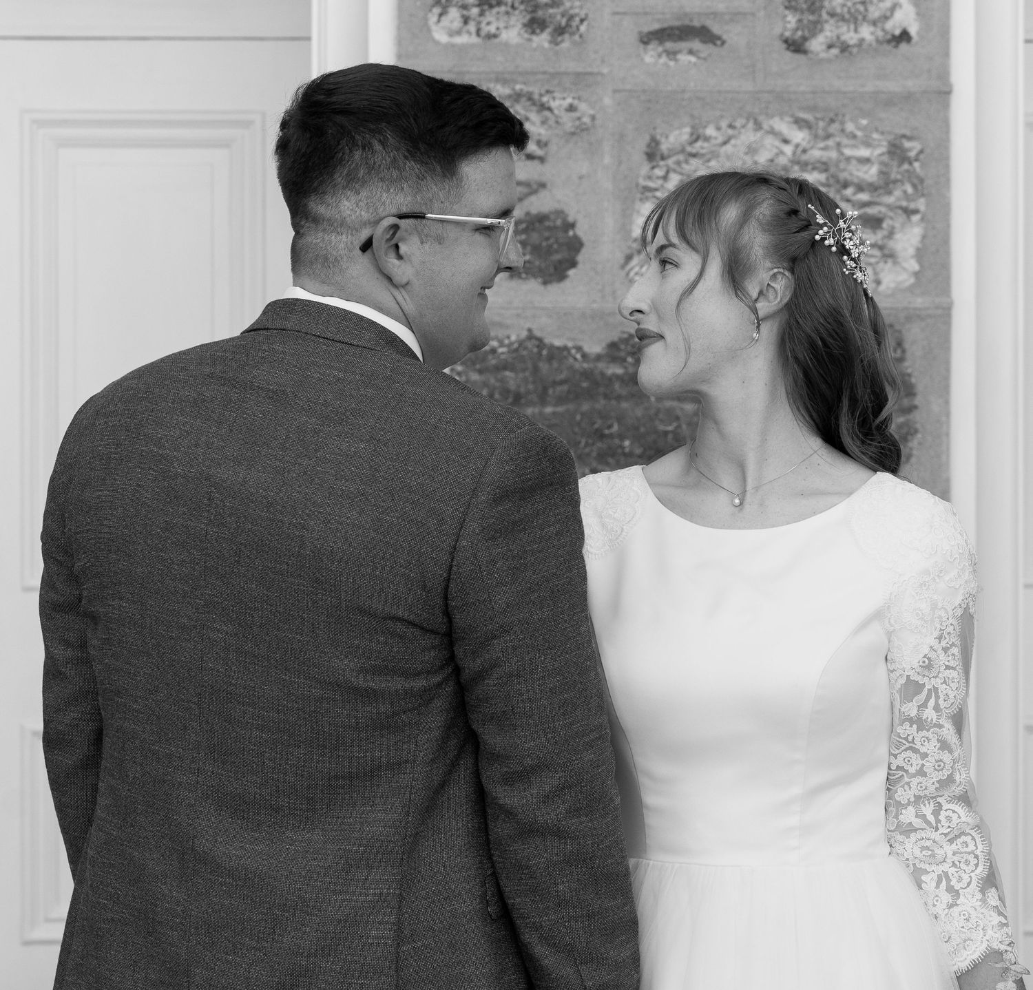 Married couple standing in front of wedding venue in logan utah